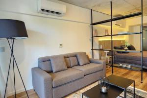 a living room with a couch and a table at Luxury Loft en Buenos AIres-Modern Design con SPA in Buenos Aires