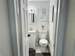 a small bathroom with a toilet and a sink at 4-A Diamond in Yonkers in Yonkers