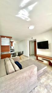 sala de estar con sofá y TV de pantalla plana en Comodo departamento en Playa el Angel, en Pampatar
