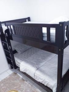 a black bunk bed with a white mattress at Blessed Rest house in Dubai