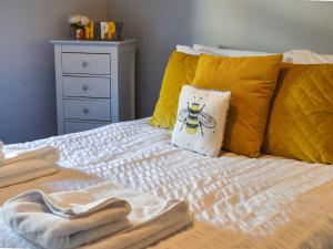 a bed with towels and a pillow on it at Hugh Cottage in Whitehaven