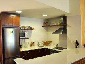 a kitchen with a refrigerator and a microwave at Casa Rural Bigotes in Arlanzón