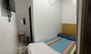 a small room with a bed and a swimming pool at Calo Apartel in Panabo