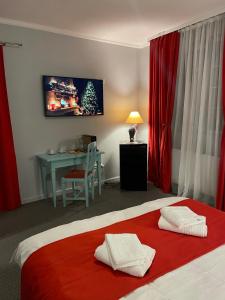 a hotel room with a bed with a red blanket at Vila De Argint in Sinaia