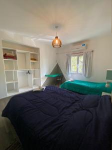 a bedroom with a large bed and a window at Departamento Céntrico in Termas de Río Hondo