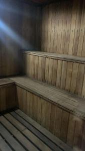 a wooden cabin with three wooden shelves in it at Royal Ibirapuera Park in Sao Paulo