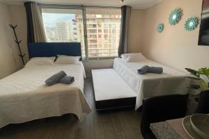 מיטה או מיטות בחדר ב-Apartamento en Santiago.