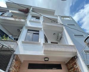 a white building with windows on the side of it at Phuc Khang Apartment in Ho Chi Minh City