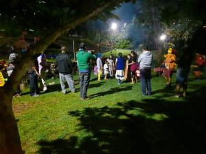 a group of people standing in a park at night at Lilly's Valley Resort in Kodaikānāl