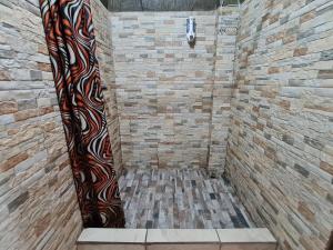a shower with a large curtain in a bathroom at Cabina Arenal Z13 in Fortuna