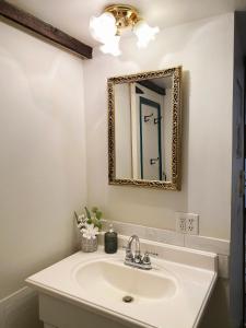 a bathroom with a sink and a mirror at Charming & Cozy - Breathtaking Lake & Sunset Views in Harveys Lake