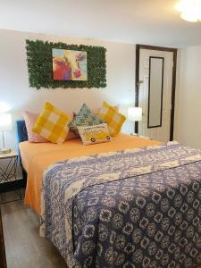 a bedroom with a bed with colorful pillows at Charming & Cozy - Breathtaking Lake & Sunset Views in Harveys Lake