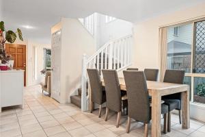 a dining room with a wooden table and chairs at Luxurious Urban Eco Escape 3br in Brisbane