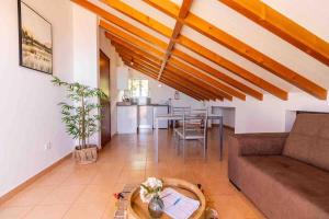 a living room with a couch and a table at Apartment 1BR Hills over Ponta do Sol, sea view in Ponta do Sol