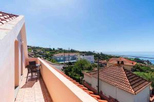 a balcony of a building with a view of the ocean at Apartment 1BR Hills over Ponta do Sol, sea view in Ponta do Sol