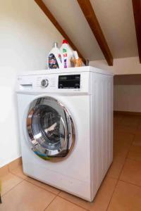 a white washing machine sitting in a room at Apartment 1BR Hills over Ponta do Sol, sea view in Ponta do Sol