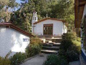 a small white church with stairs in front of it at Truchera San José in Belmira