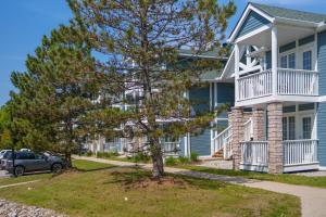 a house with a tree in front of it at Horseshoe Valley Suites - The Maple in Shanty Bay