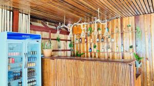 a bar with a refrigerator and bottles of alcohol at Koh Rong 71 Guesthouse in Koh Rong Island