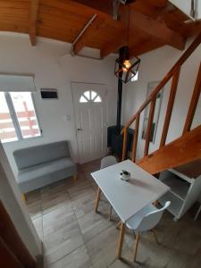 a living room with a white table and chairs at La Guanaca in Perito Moreno