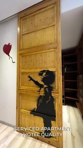 a wooden garage door with a painting of a soldier at Serviced Apartment Pretty Penthouse Valencia in Valencia