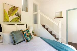 a bedroom with a bed and a stair case at Two-Acres Italian villa creek setting - 3 bedroom in Bridgewater