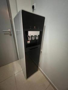 a refrigerator in a bathroom with its door open at Seeds Hotel Cheras Maluri in Kuala Lumpur