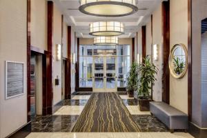 a hallway in a building with a large chandelier at Princess Suite * Platinum Hotel with balcony Strip VIEW in Las Vegas