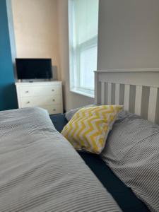 a bed with a pillow and a dresser in a bedroom at Castle Lodge in Nottingham