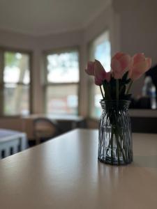 eine Vase rosafarbener Blumen auf einem Tisch in der Unterkunft Castle Lodge in Nottingham