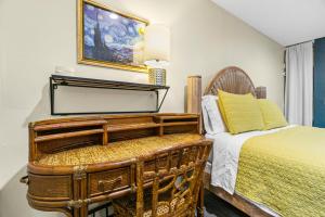 a bedroom with a bed and a table and a chair at Mile to Beach! Tiki Master Suite in Oceanside