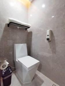 a bathroom with a white toilet and a shower at Connar Hotel - Shenzhen Futian in Shenzhen