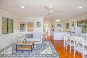 a living room with a couch and a table at The Cottages On Mount Tamborine in Mount Tamborine