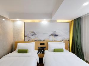 Postel nebo postele na pokoji v ubytování Connar Hotel - Shenzhen Futian