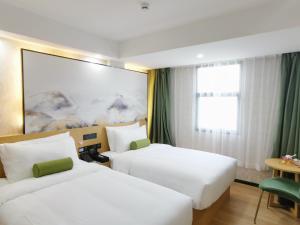 Postel nebo postele na pokoji v ubytování Connar Hotel - Shenzhen Futian