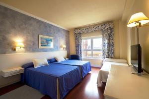 Posteľ alebo postele v izbe v ubytovaní Hotel Guadalquivir