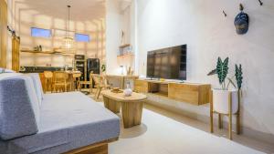 a living room with a couch and a tv in it at Alaya Homes D - Chic Japandi Loft Suite in Seminyak in Seminyak