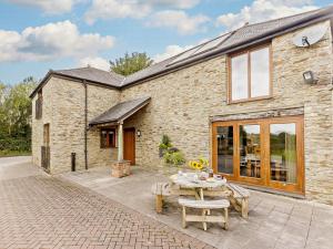 a stone house with a patio and a table at 3 Bed in Launceston BRWHI in Launceston