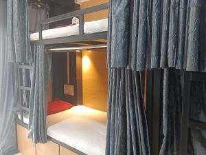 a room with two bunk beds with a curtain at MY DORMITORY in Mumbai