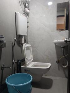a bathroom with a toilet and a sink at MY DORMITORY in Mumbai