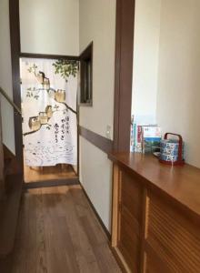 a room with a door with a painting of birds on the wall at ZY House in Osaka