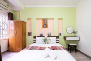 a bedroom with a large white bed in a room at Planet Homestay in Ho Chi Minh City