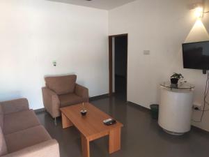 a living room with a couch and a coffee table at Habour view in Galle