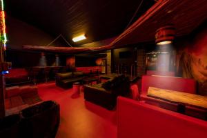 a room with couches and chairs in a room with at FDTD Party & Sauna Lounge in Lahti