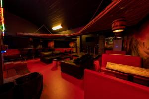 a living room with couches and a table and chairs at FDTD Party & Sauna Lounge in Lahti