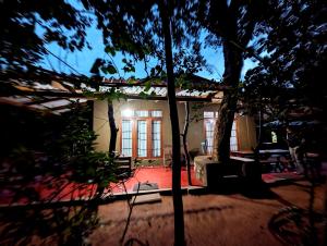 una piccola casa bianca con degli alberi di fronte di Wilpattu Mookalan Resort a Habawewa