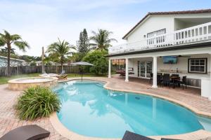 a swimming pool in front of a house at Escondida Drive in West Palm Beach