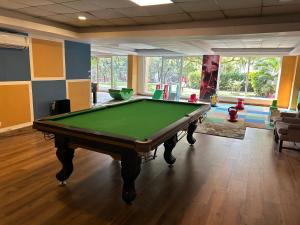 a billiard room with a pool table in it at Aloha - Luxury Apartments by blissful Ganges in Rishīkesh