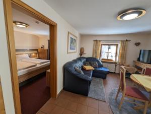 a living room with a couch and a bed at Ferienwohnung Jodlschmid in Ruhpolding