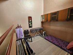 a room with baseball equipment on the floor at Homestay LaNik Saujana Utama 2 in Sungai Buluh +7 photos